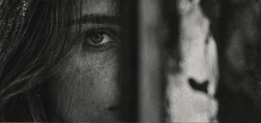 An intimate black and white close-up through glass